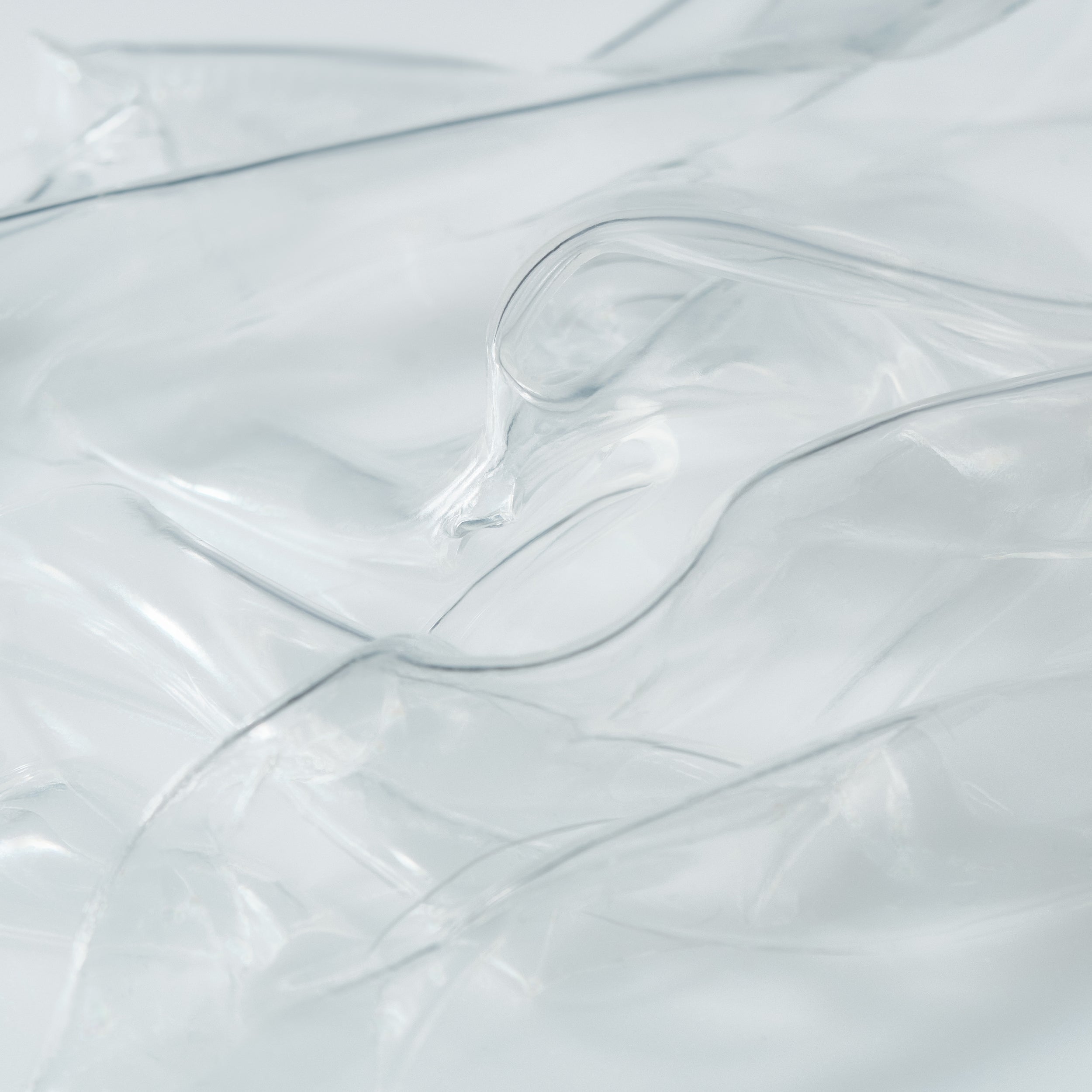 Close-up of transparent hydrogel mask sheets layered to highlight their smooth, ultra-thin texture
